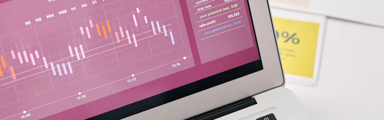 Business charts on a laptop and printed reports